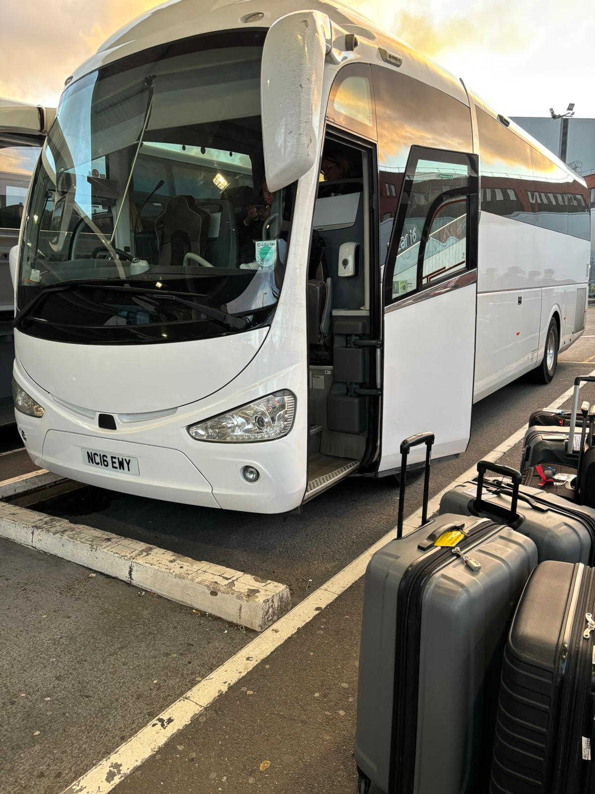 White coach parked in London, ready for passenger embarkation for an event or airport transfer.