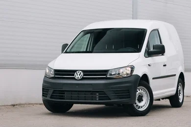 White medium-sized van operating in an urban setting in Leicester.